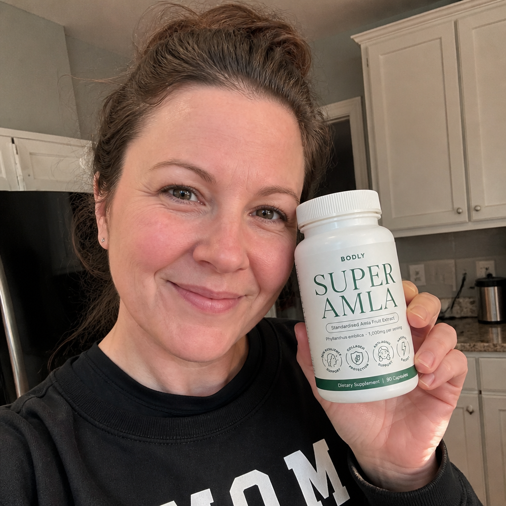 Sarah holding a bottle of Super Amla™ in her kitchen